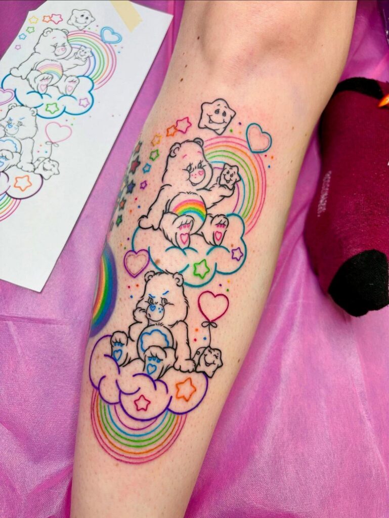 Care Bear tattoos on a forearm featuring colorful rainbows, clouds, and hearts.